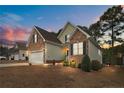 Charming two-story home with a two-car garage and stone and siding exterior at 55 London Way, Spring Lake, NC 28390