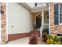 A close up of the front entrance featuring brick steps and stone and siding exterior at 55 London Way, Spring Lake, NC 28390