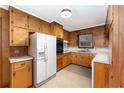 Retro kitchen with wood cabinets and white appliances at 1600 Dogwood Acres Dr, Sanford, NC 27330