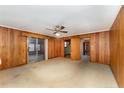 Spacious living area with wood paneling and sliding doors at 1600 Dogwood Acres Dr, Sanford, NC 27330