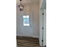 Entryway with a modern light fixture and a view to the outdoors through the front door at 23 Surles Landing Way, Benson, NC 27504
