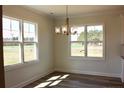 Bright dining area with large windows and modern lighting at 24 Surles Landing Way, Benson, NC 27504