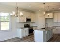 Bright kitchen with stainless steel appliances, granite countertops, and a center island at 24 Surles Landing Way, Benson, NC 27504