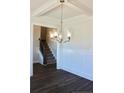 Dining room view featuring decorative chair rail, hardwood floors and elegant light fixture at 48 Surles Landing Way, Benson, NC 27504