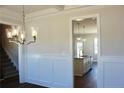 Dining room view into open floor plan, with elegant lighting and hardwood floors at 48 Surles Landing Way, Benson, NC 27504