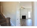 A view of the staircase leading to the living room with a cozy fireplace at 48 Surles Landing Way, Benson, NC 27504