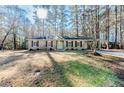 Ranch house with a spacious lawn and mature trees at 54 Red Holly Dr, Sanford, NC 27330