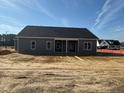 New construction featuring a covered porch, gray vinyl siding, and a spacious backyard at 55 Surles Landing Way, Benson, NC 27504