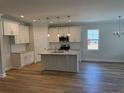 Modern kitchen with granite countertops, island, and stainless steel appliances at 79 Surles Landing Way, Benson, NC 27504
