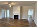 Spacious living room with fireplace, ceiling fan, and hardwood floors at 79 Surles Landing Way, Benson, NC 27504
