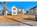 Two-story house with white siding, a brick base, and a small front porch at 107 N 12Th St, Erwin, NC 28339