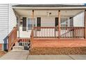 Close-up of the porch with a brick foundation and wood railing at 107 N 12Th St, Erwin, NC 28339