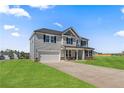 Beautiful two-story home with an attached two-car garage and a spacious, well-maintained lawn at 115 White Doe Xing, Cameron, NC 28326