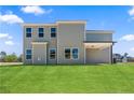The back of a two-story home showcasing large windows and a covered patio area at 115 White Doe Xing, Cameron, NC 28326