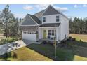 Attractive home with a two-car garage and a well-manicured lawn, complemented by surrounding trees at 501 Stadium Dr, Cameron, NC 28326