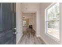 Inviting entryway showcasing wood-look flooring leading to a living area with a fireplace at 69 Onslow Ct, Spring Lake, NC 28390