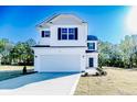 Charming two-story home featuring a pristine white exterior, black shutters, and well-manicured lawn at 69 Onslow Ct, Spring Lake, NC 28390