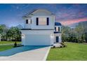 Charming two-story home featuring a pristine white exterior, black shutters, and well-manicured lawn at 69 Onslow Ct, Spring Lake, NC 28390