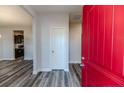 Welcoming foyer with a vibrant red door and modern flooring leading to the kitchen and other rooms at 87 Onslow Ct, Spring Lake, NC 28390
