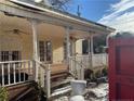 Inviting front porch with white railings and brick steps at 103 N Mckay Ave, Dunn, NC 28334