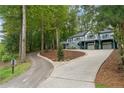 Two-story home with a wraparound deck, two-car garage, and landscaped yard at 15 The Pointe, Sanford, NC 27332