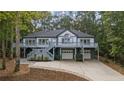 Two-story home with a wraparound deck and two-car garage at 15 The Pointe, Sanford, NC 27332