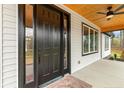 Close up of front door and entryway with wood ceiling and black door frame at 107 Georgie Dr, Broadway, NC 27505