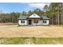 Lovely single story home with well kept front lawn and beautiful wooded backdrop at 107 Georgie Dr, Broadway, NC 27505