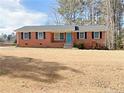 Brick ranch home with a well-maintained lawn at 207 Mcleod Dr, Sanford, NC 27330