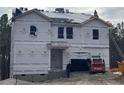 Exterior view of a home under construction, featuring weather-resistant wrap, machinery, and construction crew at 352 Rocking Horse Ln, Sanford, NC 27332
