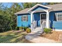 Front view of a blue house with a porch and landscaping at 206 Justice Heights St, Apex, NC 27502