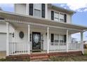 Close up of the charming front porch with classic white railing and columns at 281 Highland Forest Dr, Sanford, NC 27332