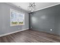 Bright dining room showcasing a feature wall, modern lighting, and wood floors at 37 Pomegranate Ct, Cameron, NC 28326