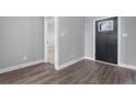 Clean entryway featuring gray walls, dark wood flooring, and a modern door at 37 Pomegranate Ct, Cameron, NC 28326