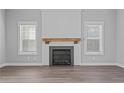 Living room with fireplace, wood mantle, and gray walls at 37 Pomegranate Ct, Cameron, NC 28326