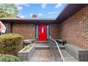 A red front door, complemented by charming benches, creating an inviting entryway at 48 Indian Trl, Sanford, NC 27332