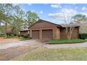 Two-car attached garage with brown doors at 48 Indian Trl, Sanford, NC 27332