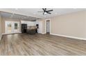 Open-concept living area with wood floors and a modern ceiling fan at 541 Delma Grimes Rd, Coats, NC 27521