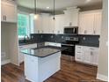 Modern kitchen with granite countertops, stainless steel appliances, and ample cabinet space at 55 Councel Williams Rd, Coats, NC 27521