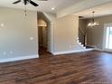 A spacious living room featuring hardwood floors, modern lighting, and plenty of natural light at 55 Councel Williams Rd, Coats, NC 27521