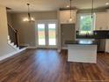 Open-concept living room featuring stainless appliances, a kitchen island and outside views at 55 Councel Williams Rd, Coats, NC 27521