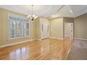 Bright living room with hardwood floors, tray ceilings, and large windows at 61 Fountain Park Cir, Spring Lake, NC 28390