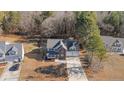 Aerial view of a two-story house with a large backyard and nearby homes at 145 Rolling Stone Ct, Sanford, NC 27332