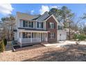 Two-story house with gray siding, brick accents, and a two-car garage at 145 Rolling Stone Ct, Sanford, NC 27332