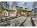 Ranch style home with attached three-car garage and landscaped yard at 3012 Bourbon St, Sanford, NC 27332