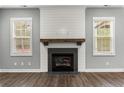 Modern fireplace with white shiplap and wood mantel at 78 Myrtle Oak Dr, Cameron, NC 28326