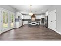 Modern kitchen with white cabinets, a large island, and stainless steel appliances at 78 Myrtle Oak Dr, Cameron, NC 28326