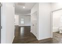 Clean hallway with dark flooring and access to bathroom at 136 Parkview Ln, Lillington, NC 27546