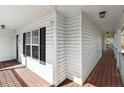 Covered front porch with stained wood floors and a white railing for a classic touch at 240 Colonial Hills Drive Dr, Lillington, NC 27546