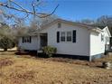 Side view of a white ranch style home with deck at 885 Dry Creek Rd, Lillington, NC 27546